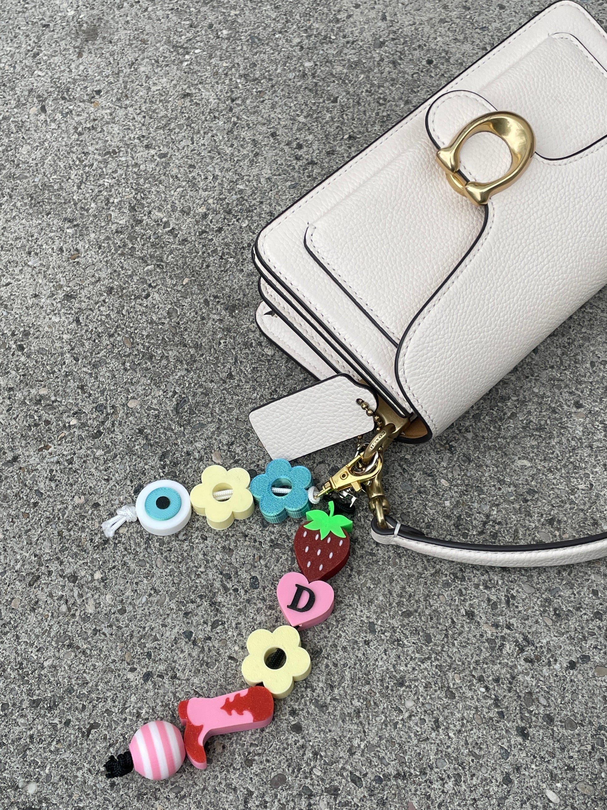 bag charms 3D printed on a Coach bag